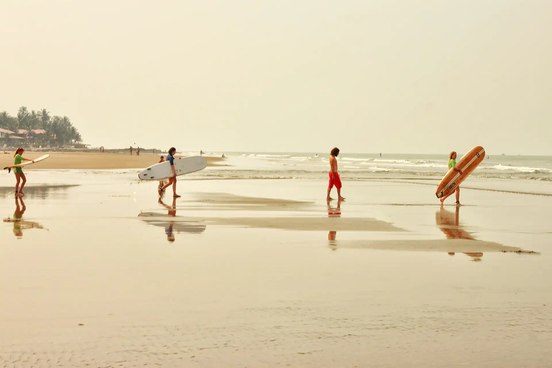 Goa beach at sunset with fishing boats on golden sand